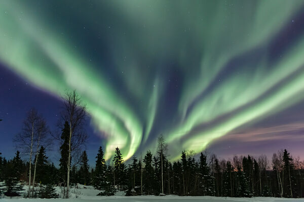 A view of the Northern Lights over an ice hotel